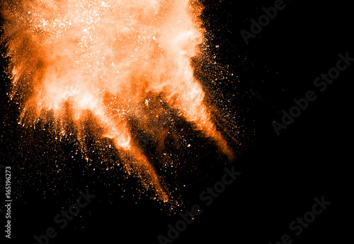 Abstract design of gold powder cloud against dark background