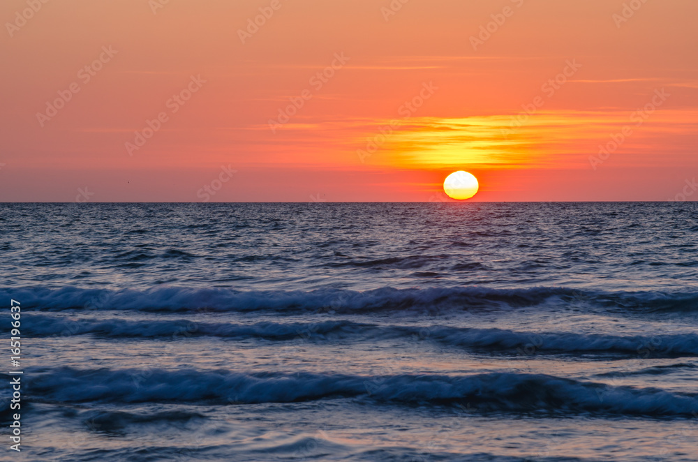 Orange Sunset over the Sea from the Coast of Cornwall, England,