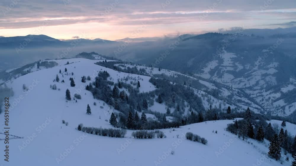 Aerial view in foggy sunset winter mountain Aerial view in foggy sunset winter mountain