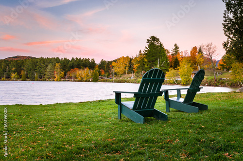 Adirondack Chairs on a Lakeside Lawn at Dusk. Beautiful Autumn Colours.