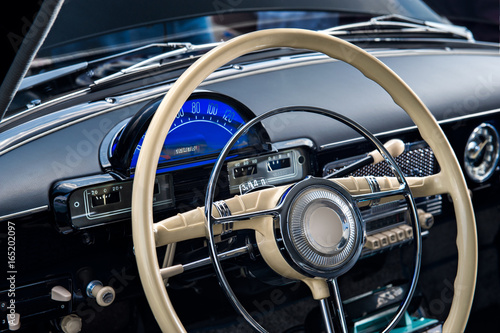 Interior of a retro car with the steering wheel