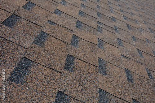 Close up view on Asphalt Roofing Shingles Background. Roof Shingles - Roofing.