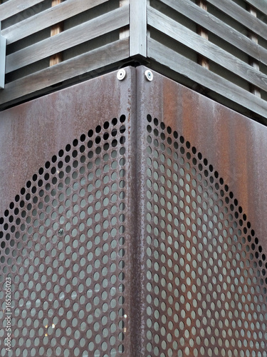 rusty metal patterned cladding joined on a corner photo