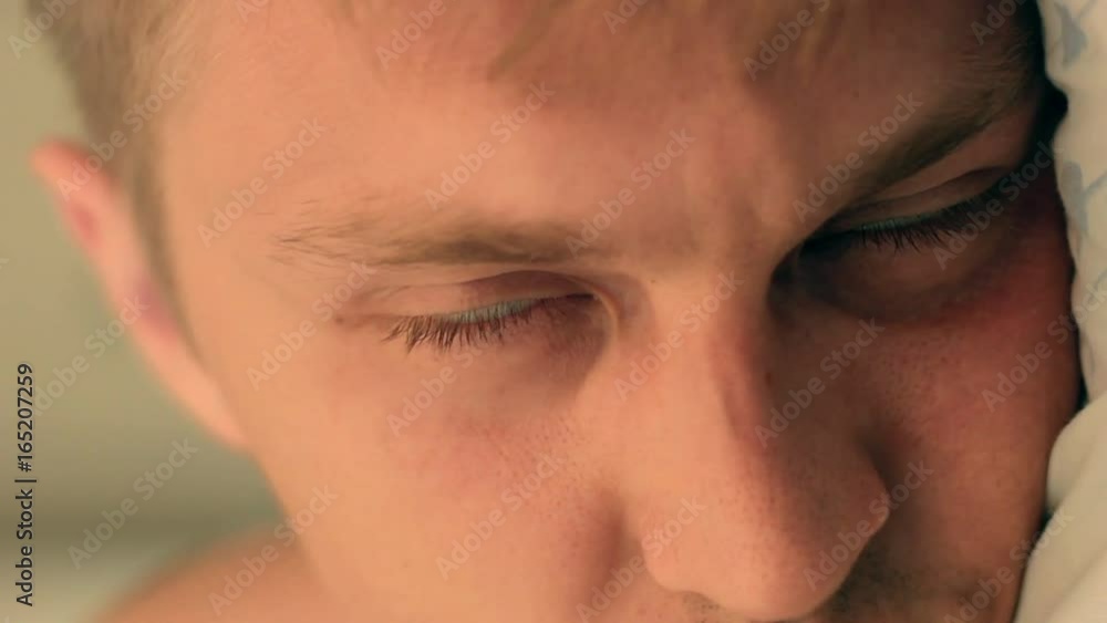 Man opening eyes in close-up Man opening eyes in close-up