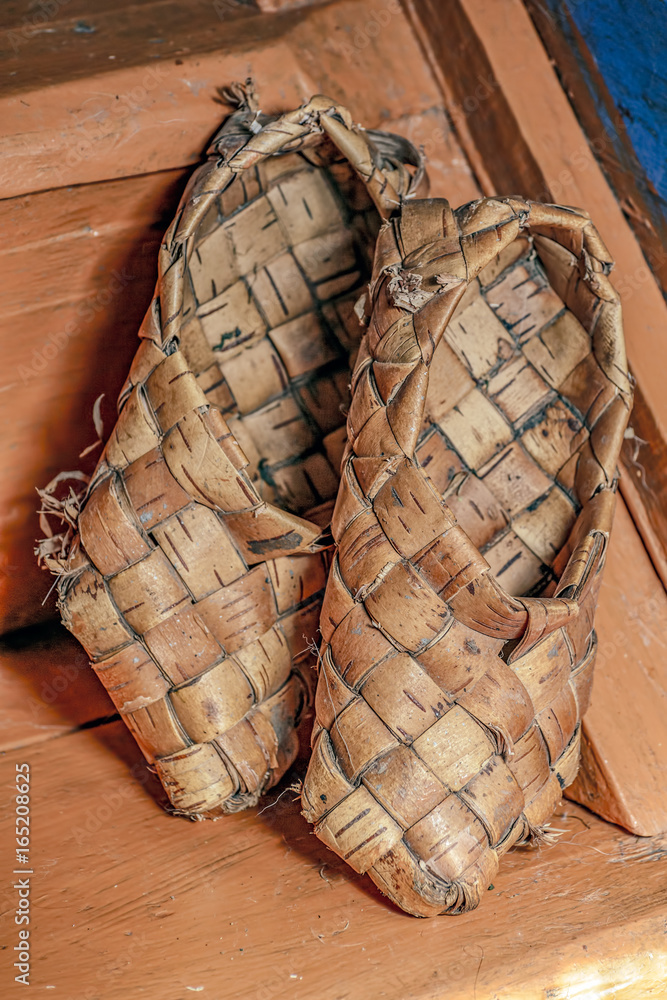Birch bast shoes on wooden background