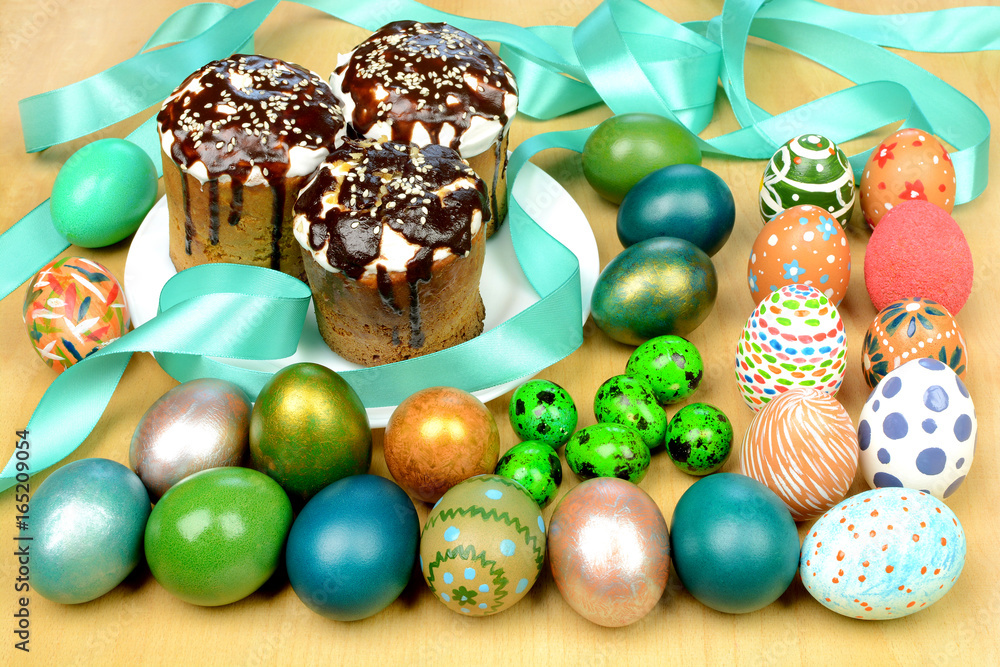 Easter eggs and muffins on a wooden table