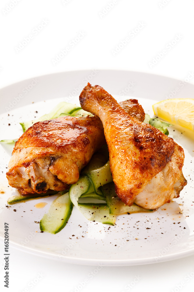 Roast chicken drumsticks on white background 