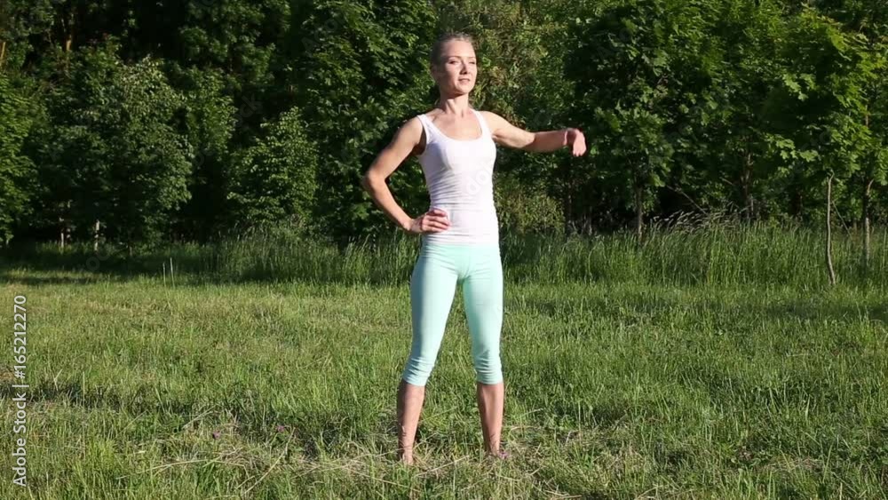 Beautiful blonde woman engaged in fitness in the park Beautiful blonde woman engaged in fitness in the park