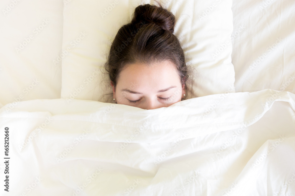 Attractive brunette young woman sleeping in the bed at morning time Attractive brunette young woman sleeping in the bed at morning time