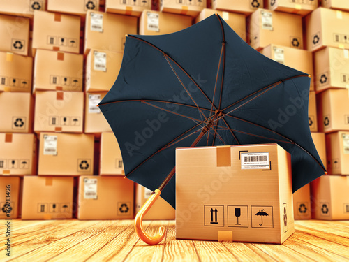 Freight cargo protection and package safety assurance concept, cardboard box with barcode under umbrella in the parcel warehouse photo