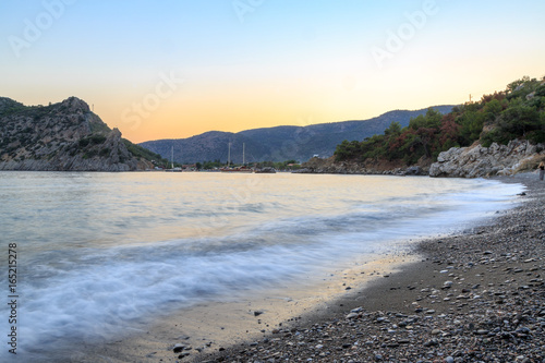 Fototapeta Naklejka Na Ścianę i Meble -  Kizilca buk beach and mesutiye during sunset in Datca, Turkey