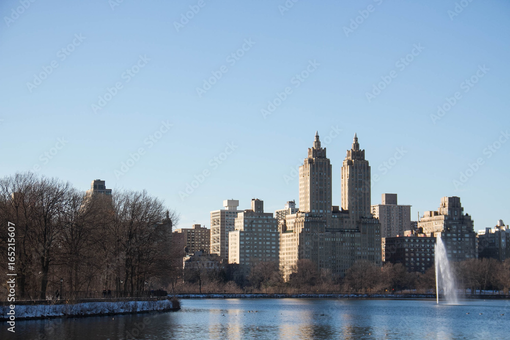 Buildings in Manhattan and lake at Central Park