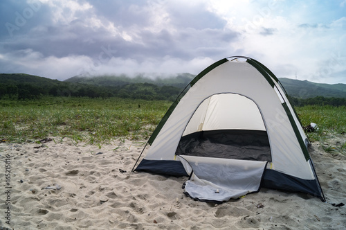 tourist tent on the sandy shore © Aboltin