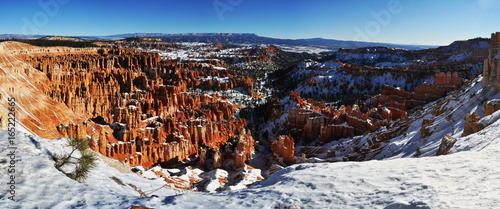 Panoramic view of the Bryce Canyon red rock formation (fairy chimneys) with snow in winter