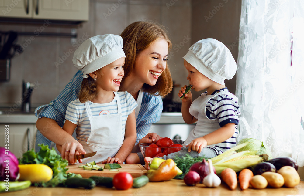 Healthy eating. Happy family mother and children prepares vegetable salad Healthy eating. Happy family mother and children prepares vegetable salad