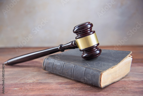 Fotografia, Obraz Judge gavel on an old book on a rustic wooden table, concept for justice in law
