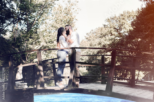 couple date on wooden bridge in the park
