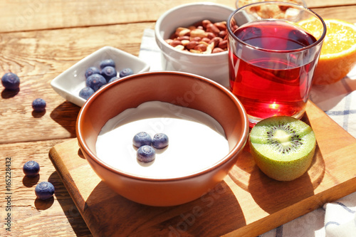 Tasty breakfast with yogurt on table