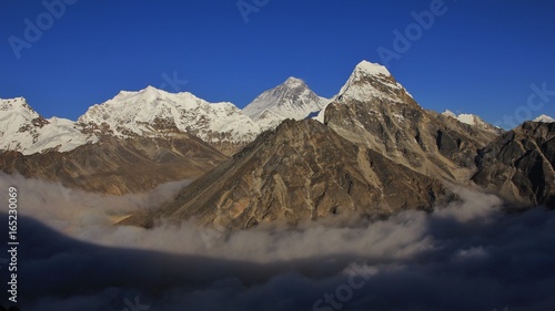 Above the clouds. High mountains Lobuche  mount Everest and Cholatse seen from the Gokyo valley.
