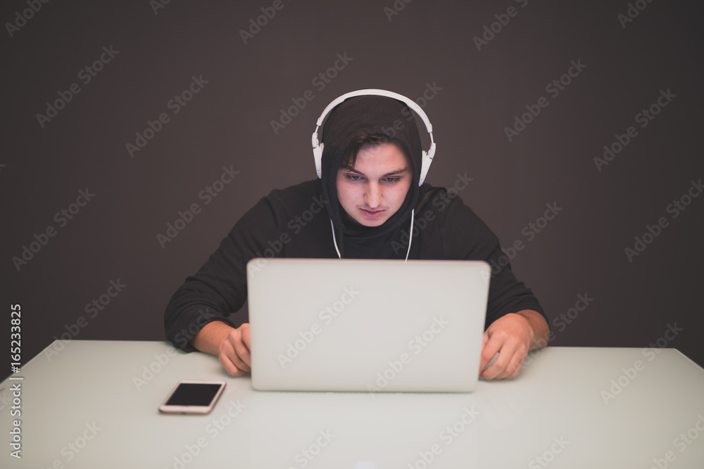 Man Hacker working on a laptop on table Man Hacker working on a laptop on table