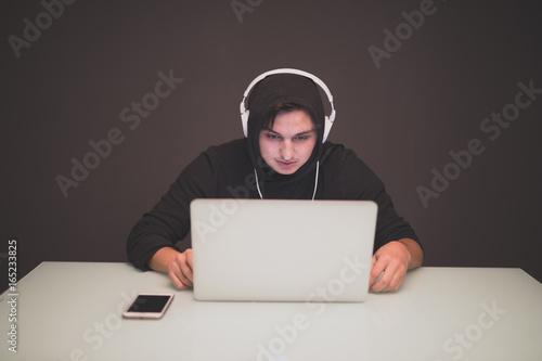 Man Hacker  working on a laptop on table