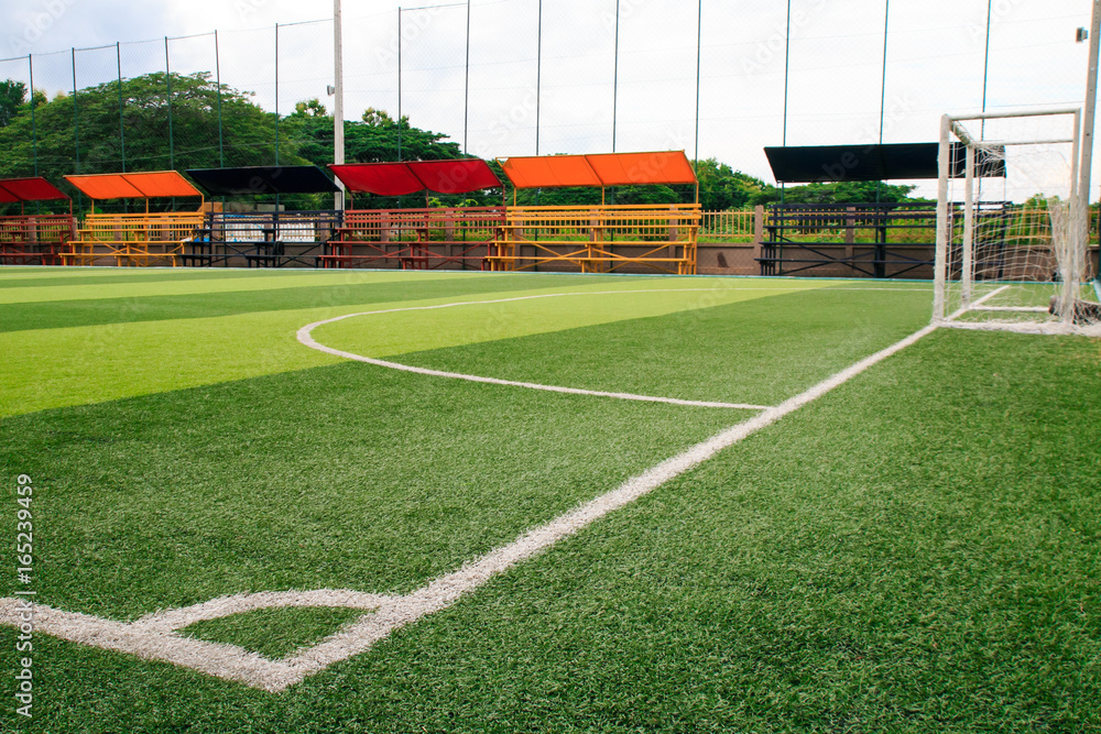 Obraz premium Photo of a green synthetic grass sports field with white line shot from above