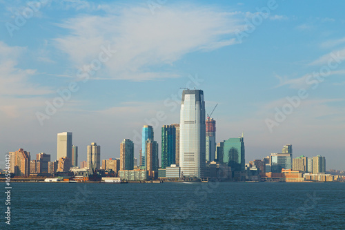 Panorama of Lower Manhattan from the water, New York, USA. Skyscrapers of Manhattan are illuminated by afternoon sun. © avmedved