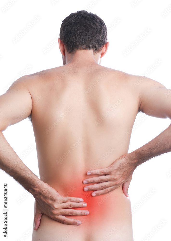 Studio shot of young man with pain in back Studio shot of young man with pain in back