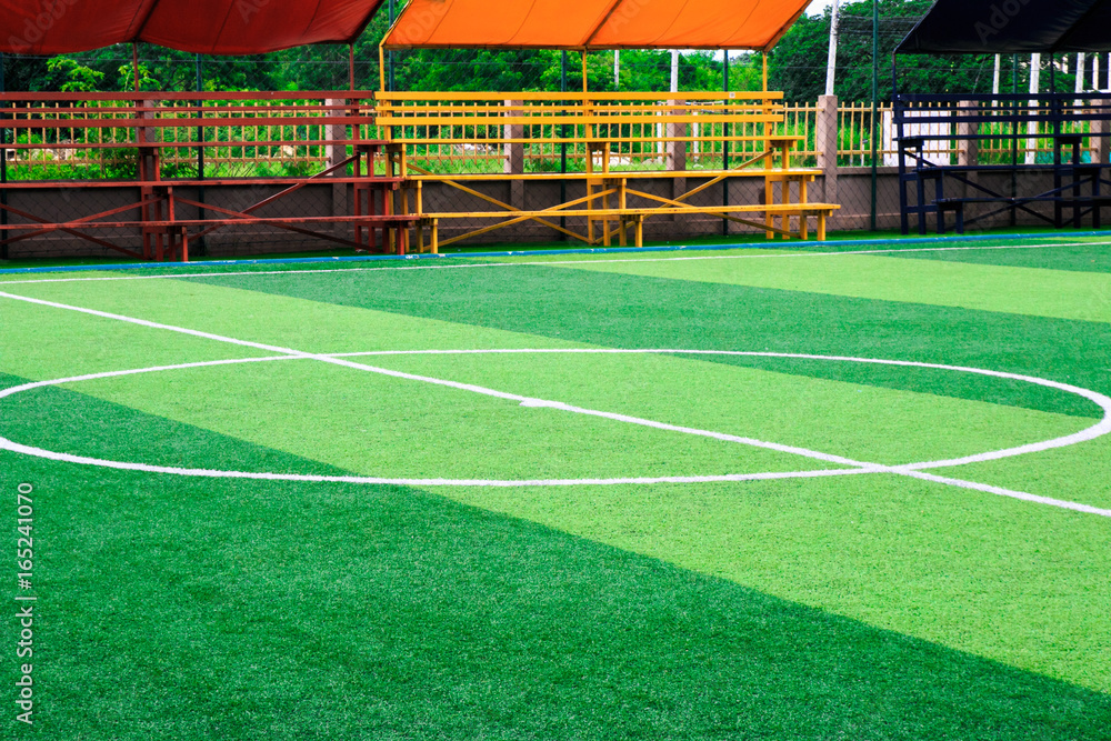 Obraz premium Photo of a green synthetic grass sports field with white line shot from above