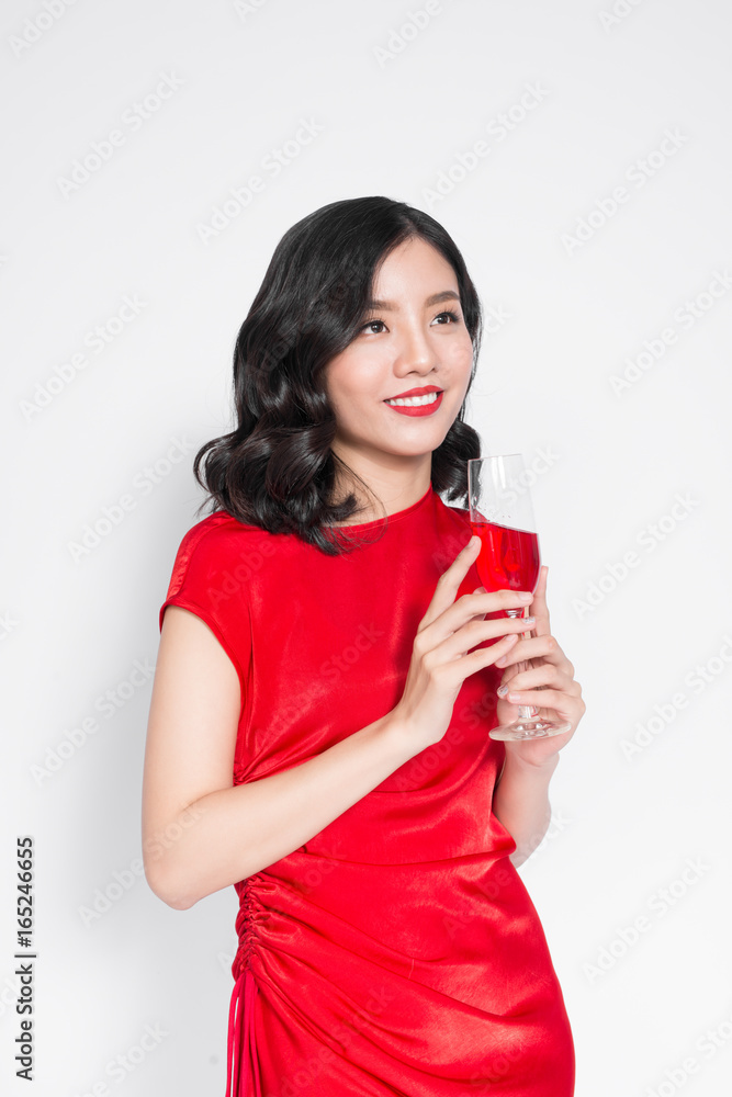 Beautiful asian girl in evening dress smiling holding glass of champagne Beautiful asian girl in evening dress smiling holding glass of champagne