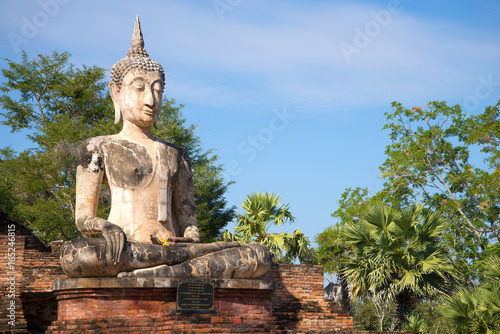 Ancient sculpture of a seated Buddha on the ruins of the Buddhist temple of Wat Mae Chon in Sukhothai  Thailand
