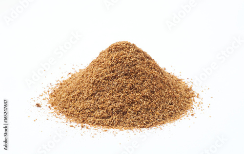 Heap of cumin powder on white background photo