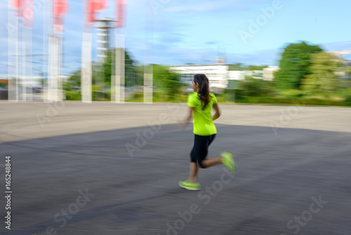 Woman wearing sportswear running outdoors © michaelheim