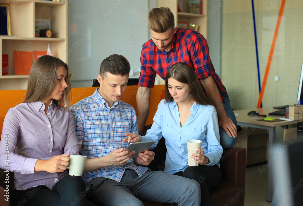 Smiling business people using tablet in office. Smiling business people using tablet in office.