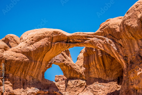 Double arch. Natural picturesque stone arch of sandstone in the desert Moab, Utah