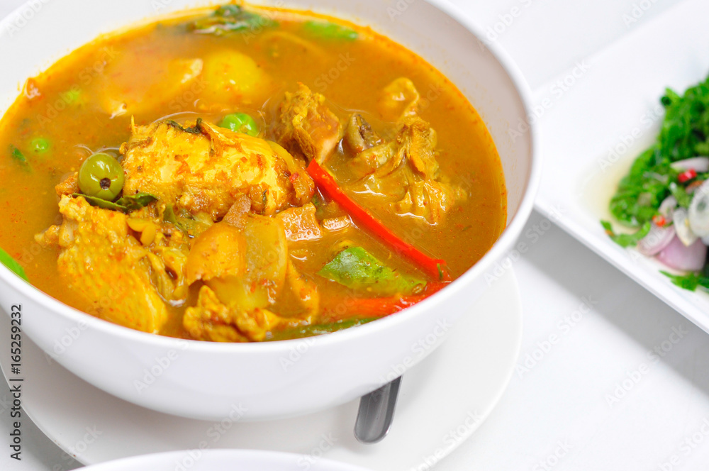 Close-up red curry with chicken in white bowl and white background Close-up red curry with chicken in white bowl and white background