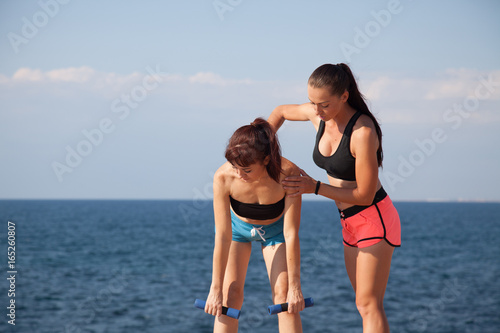 two girls play sports on the beach