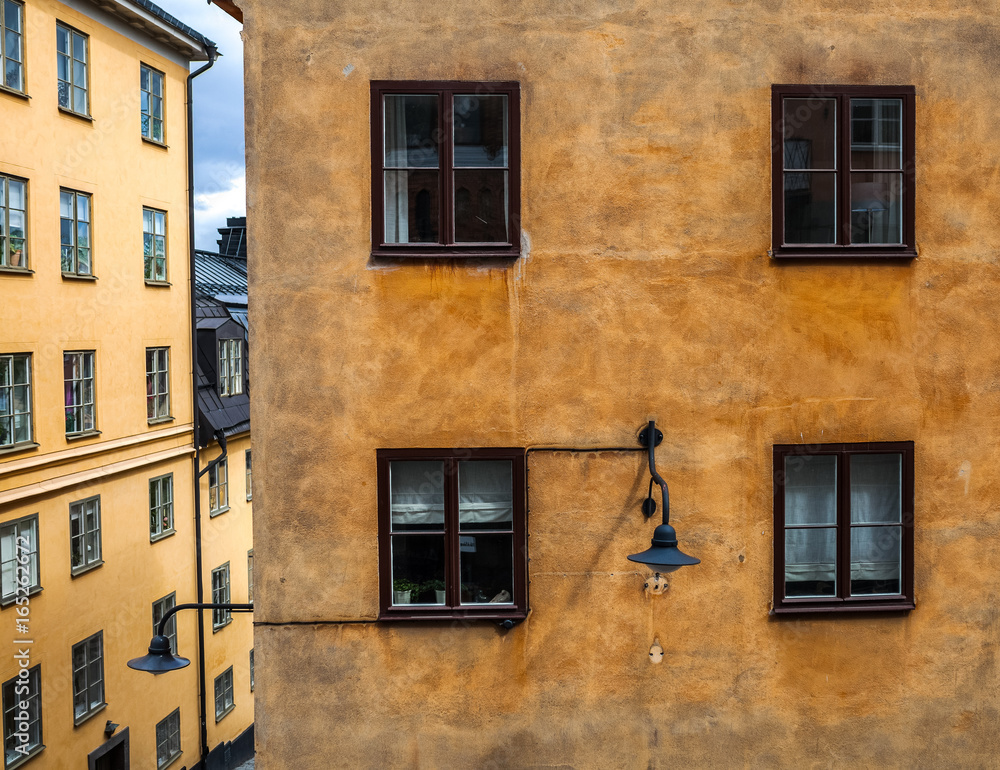 Close-up of windows of yellow old building in Stockholm, Sweden