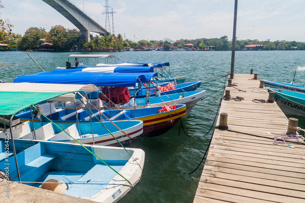 Fototapeta premium FRONTERAS, GUATEMALA - MARCH 10, 2016: Boats at Rio Dulce river at the pier in Fronteras town, Guatemala