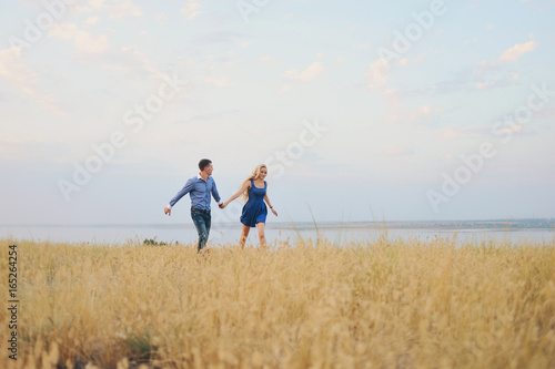 Young couple: the guy and the girl on walk, love story
