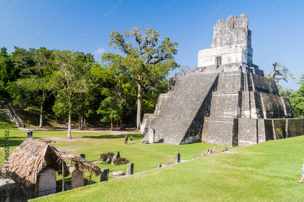 TIKAL, GUATEMALA - MARCH 14, 2016: Tourists visit Grand Plaza at the archaeological site Tikal, Guatemala TIKAL, GUATEMALA - MARCH 14, 2016: Tourists visit Grand Plaza at the archaeological site Tikal, Guatemala