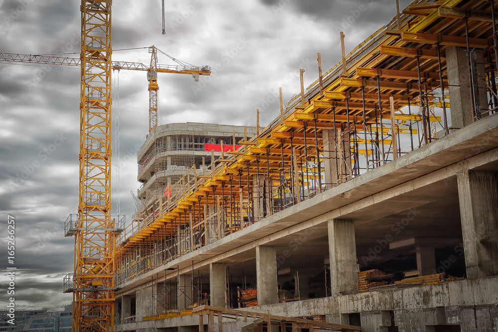 Fototapeta premium Construction site. Construction cranes, monolithic concrete walls, formwork for concrete.