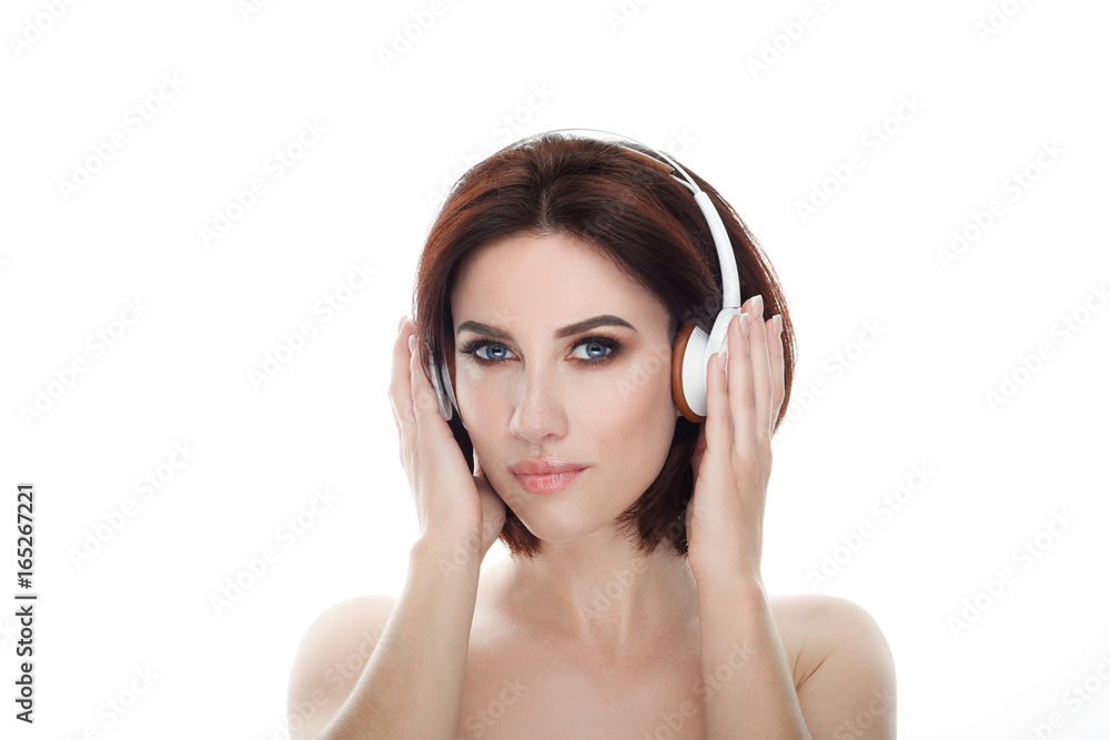 Adult adorable fresh looking brunette woman with gorgeous makeup wireless headphones bob hairdo posing against isolated white background showing emotion and facial expression concept. Adult adorable fresh looking brunette woman with gorgeous makeup wireless headphones bob hairdo posing against isolated white background showing emotion and facial expression concept.