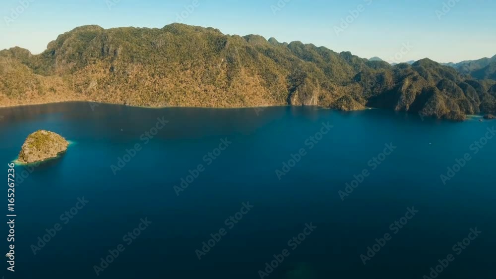 Aerial view: beach, tropical island, sea bay and lagoon, mountains with rainforest, Palawan. Lagoon with blue, azure water in the middle of small islands and rocks. Busuanga. Seascape, tropical Aerial view: beach, tropical island, sea bay and lagoon, mountains with rainforest, Palawan. Lagoon with blue, azure water in the middle of small islands and rocks. Busuanga. Seascape, tropical