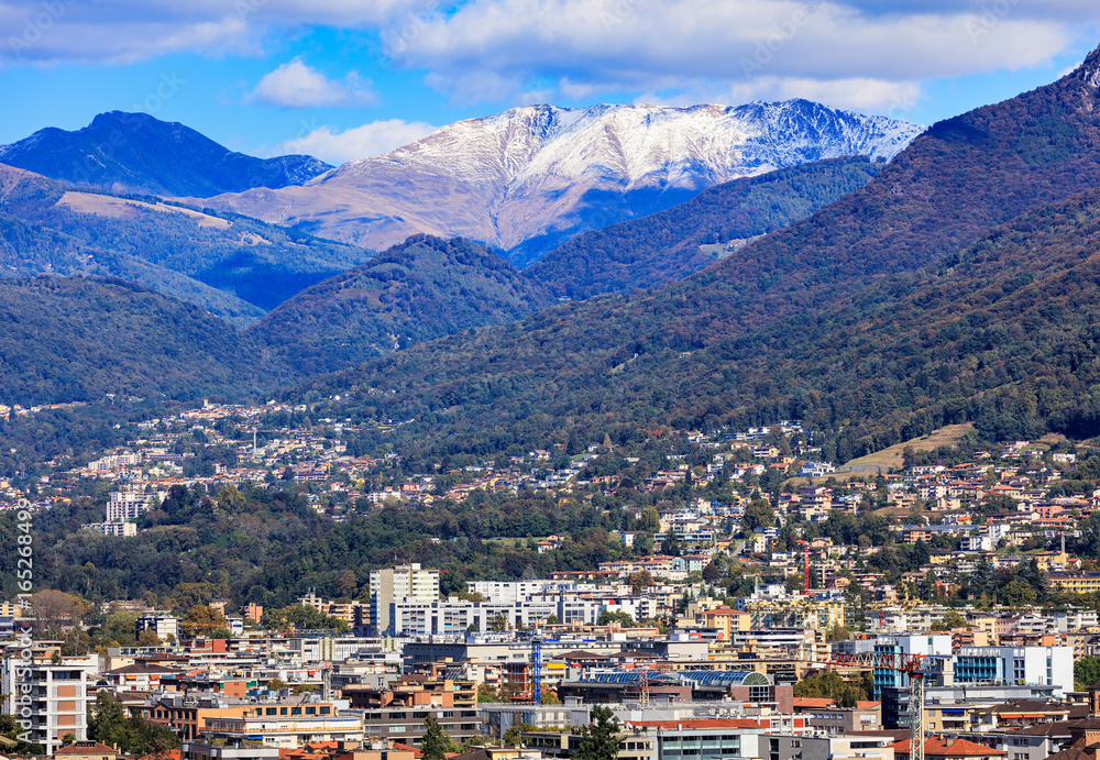 Naklejka premium Buildings of the city of Lugano in Switzerland, mountains in the background