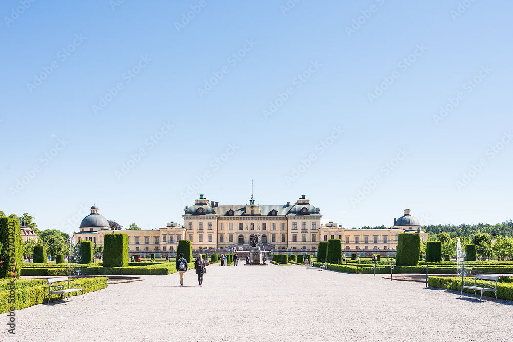 Naklejka premium View over Drottningholm Palace and park on a sunny summer day. Home residence of Swedish royal family. Famous landmark and tourist destination in Stockholm, Sweden