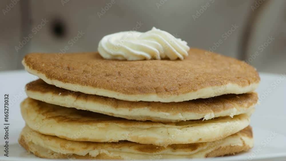 Close-up chef hands prepares pancakes with cream, strawberries and mint Close-up chef hands prepares pancakes with cream, strawberries and mint
