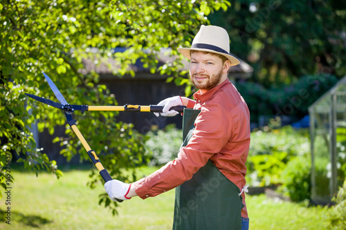 young gardener with a professional tools and equipment