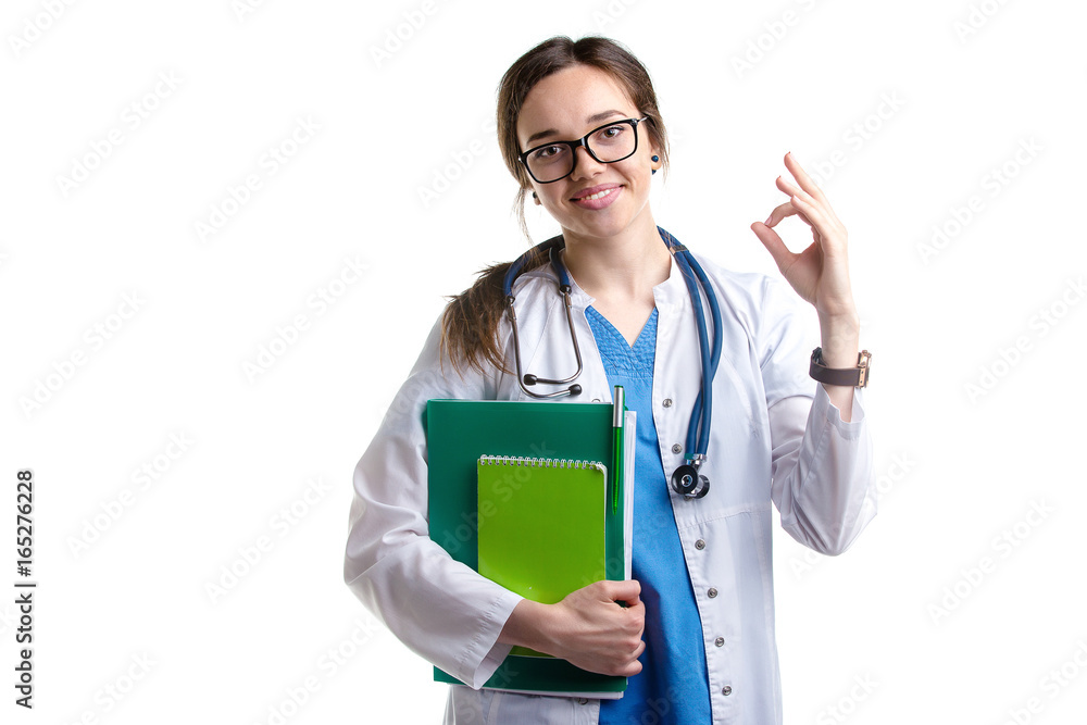 Smiling young woman doctor with stethoscope showing you Ok sign isolated on white Smiling young woman doctor with stethoscope showing you Ok sign isolated on white