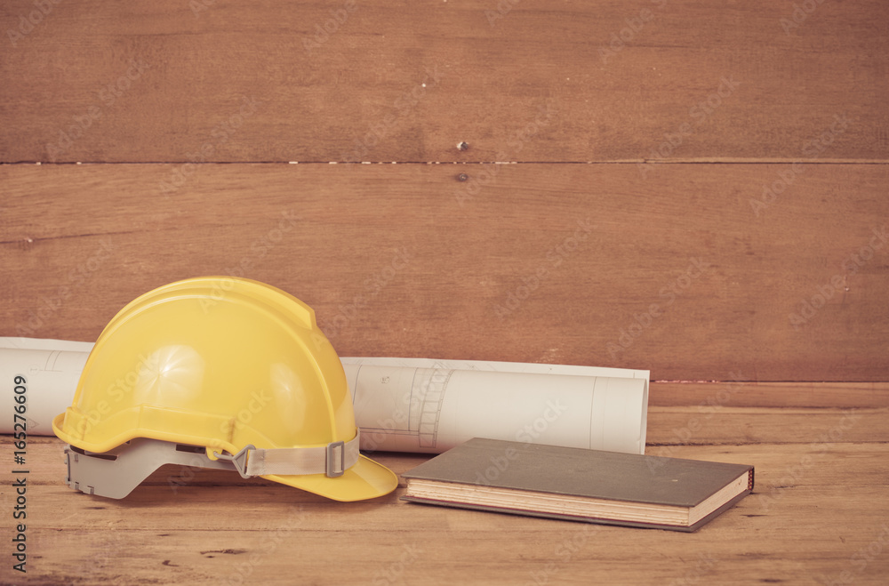 yellow construction safety helmet on wood